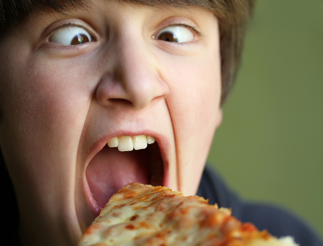 Kid eating pizza like an a-hole