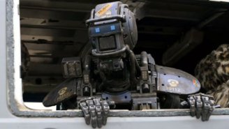 See ‘Chappie’ In Action And Hugh Jackman’s Glorious Mullet In These New Clips