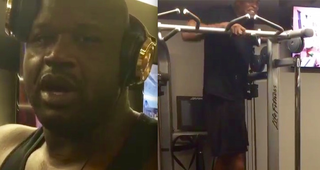 Shaquille O'Neal Lifts Weights As Chris Webber Stands On The Machine