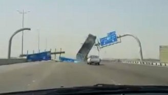 Watch This Oblivious Dump Truck Driver Run Directly Into A Highway Sign
