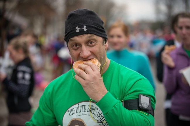 man eating a donut