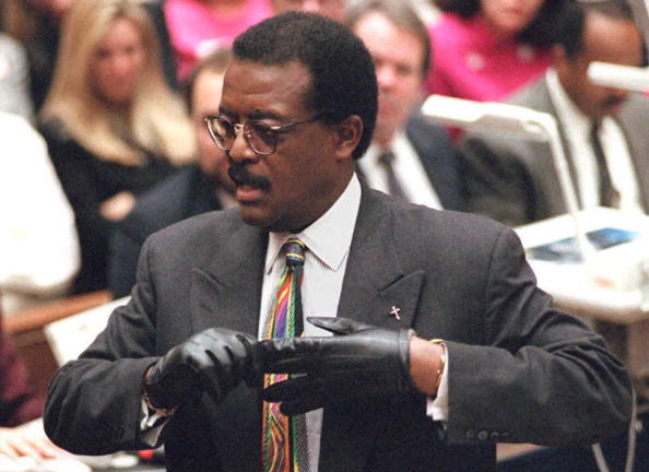 Defense lawyer Johnnie Cochran Jr. puts on a glove