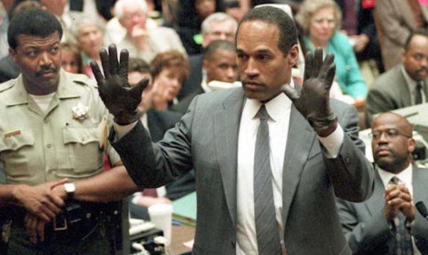 O.J. Simpson shows the jury a new pair of Aris ext