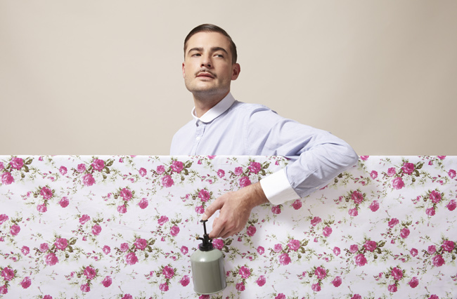 I searched Getty for "obnoxious guy" and it came back with "a dapper man spraying flowers on material."