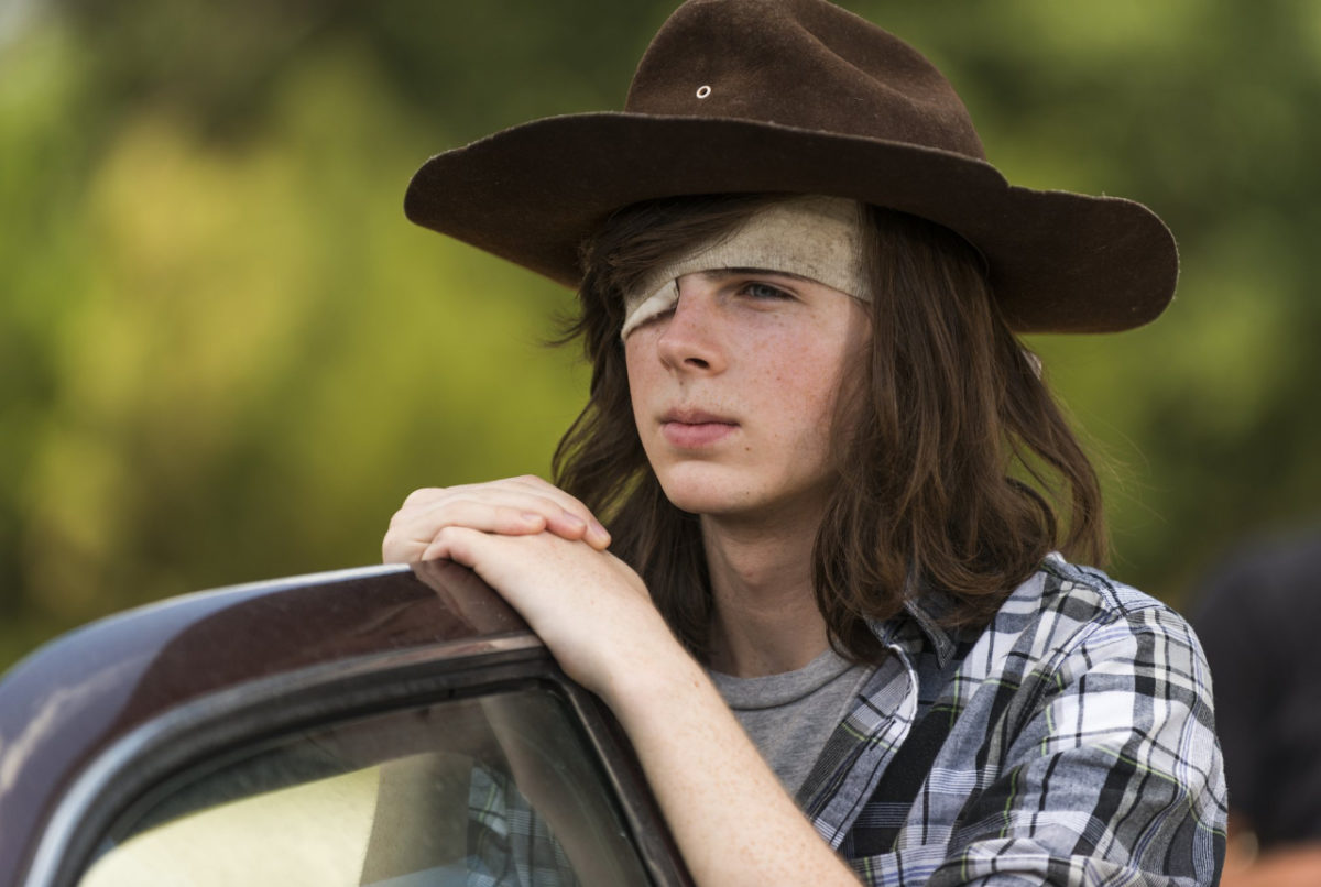 when does carl die in the walking dead