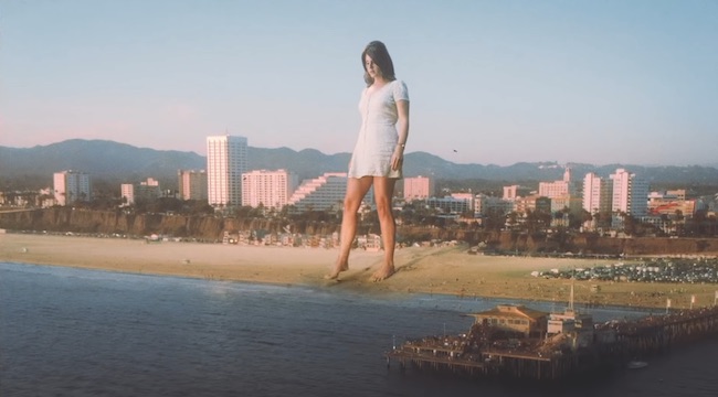 Lana Del Rey Is A Literal Giant In The Video For Her Cover Of Sublime’s ‘Doin’ Time’