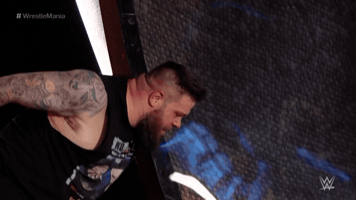 kevin-owens-wrestlemania-sign-dive.gif