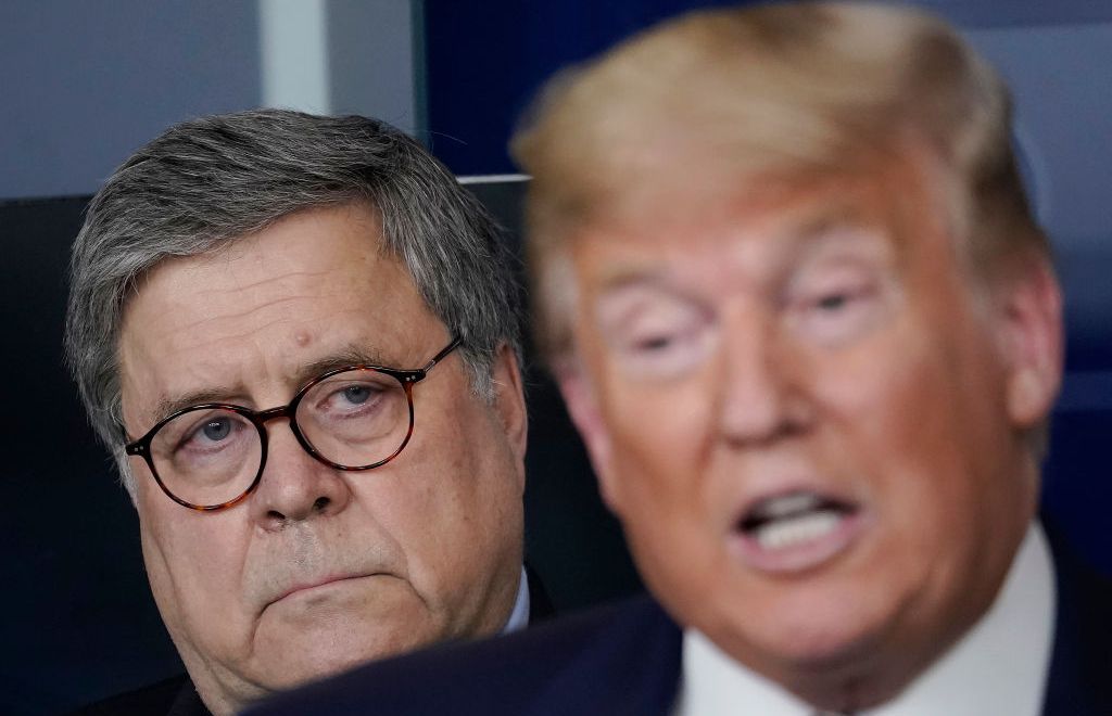 Attorney General William Barr (L), listens to U.S. President Donald Trump speak at the daily coronavirus briefing at the White House on March 23, 2020 in Washington, DC