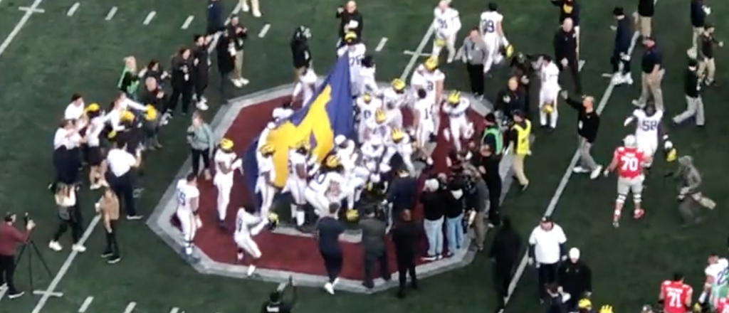 Michigan Players Plant Flag At Midfield After Beating OSU