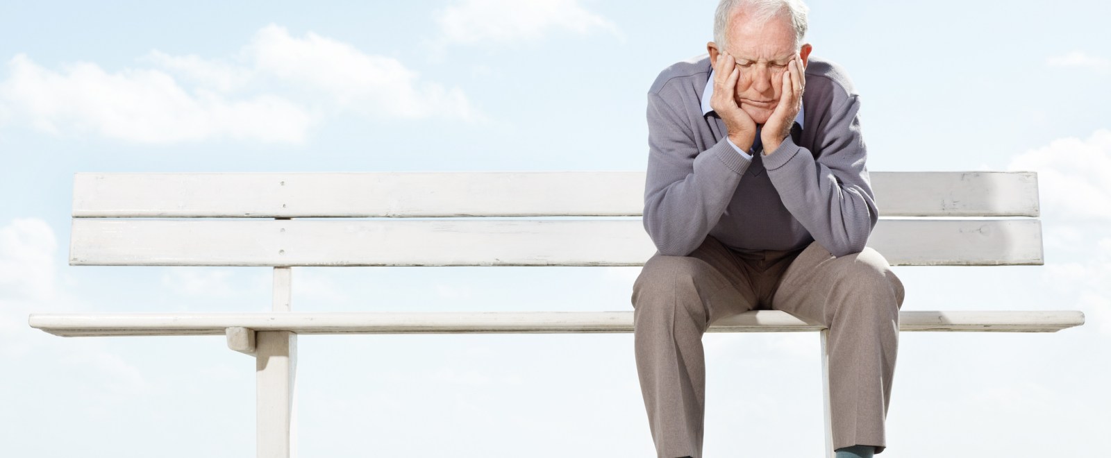 Old man in pain on bench