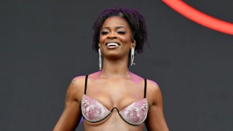 A Helmet-Wearing Ari Lennox Is Prepared For Any And All Objects Concertgoers Attempt To Throw Onstage